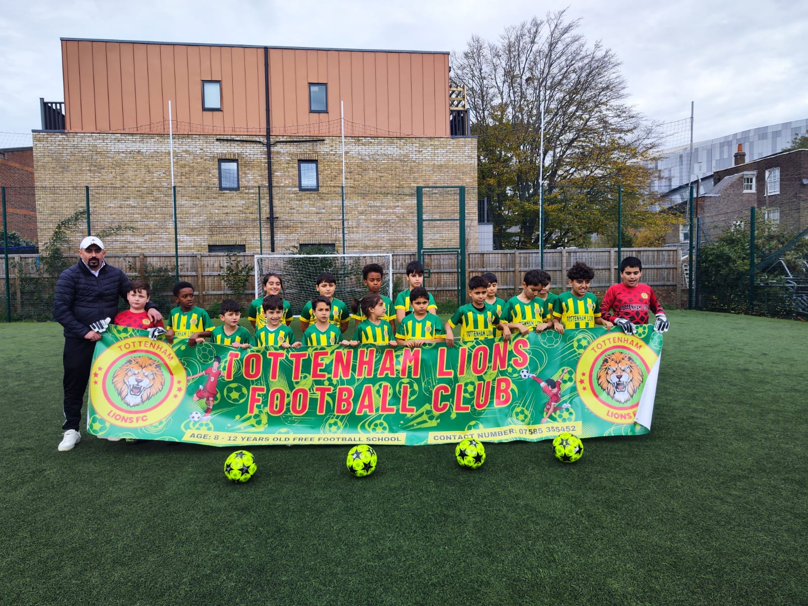 Team and coach ILHAN MİRAN GÖK posing in front of a building facade
